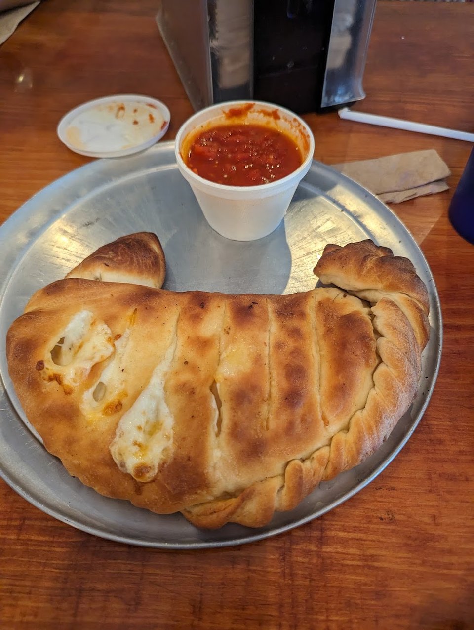 Restaurant menu with beer, soda, and garlic bread.