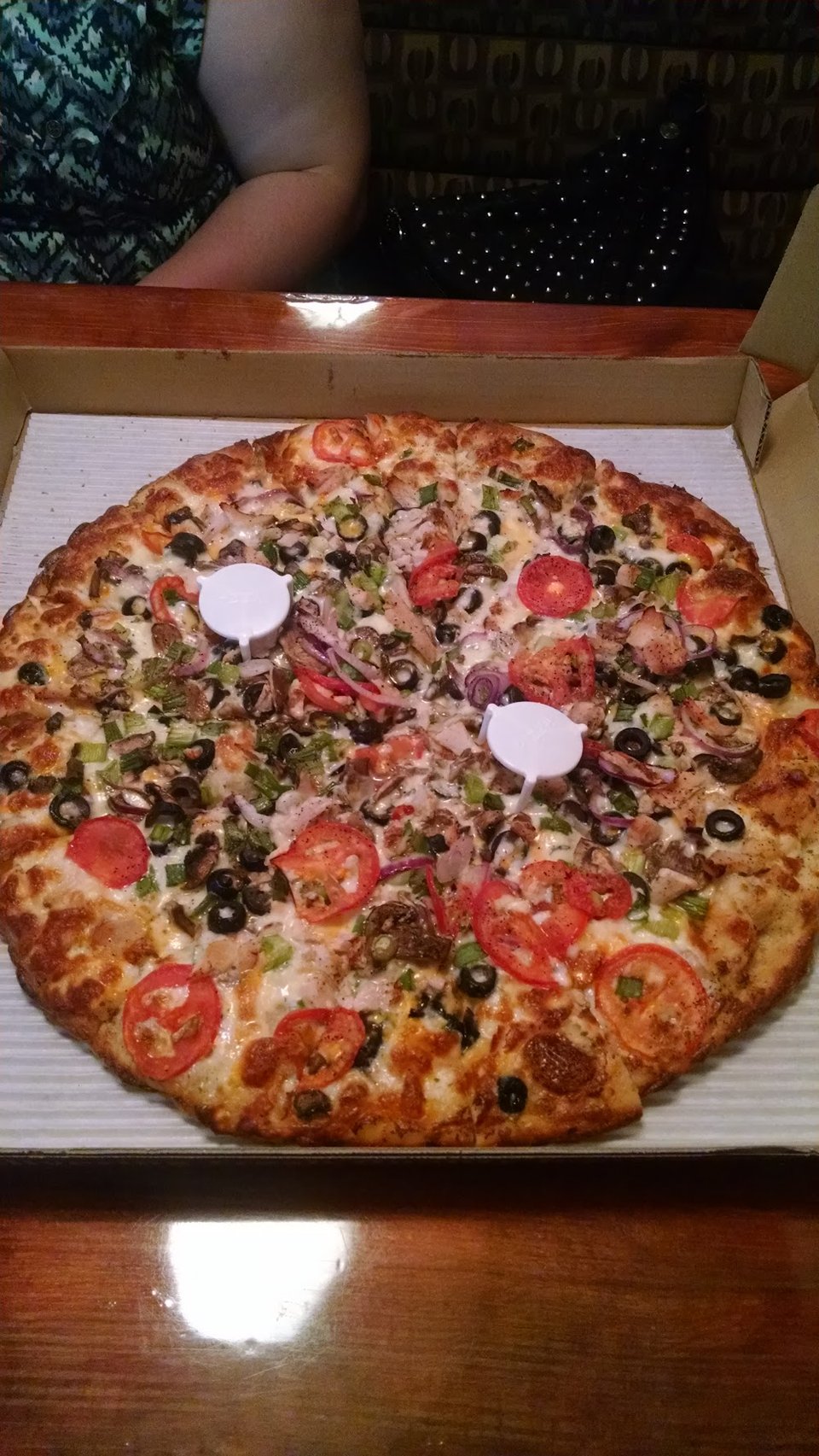 Printed menu with pizzas, sides, and drinks.