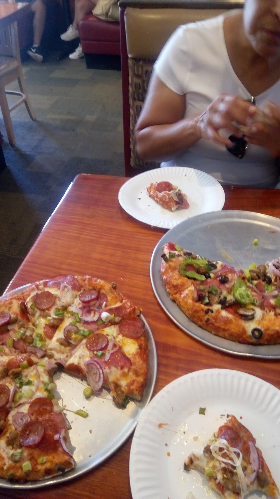 Printed menu with pizzas, sides, and drinks.